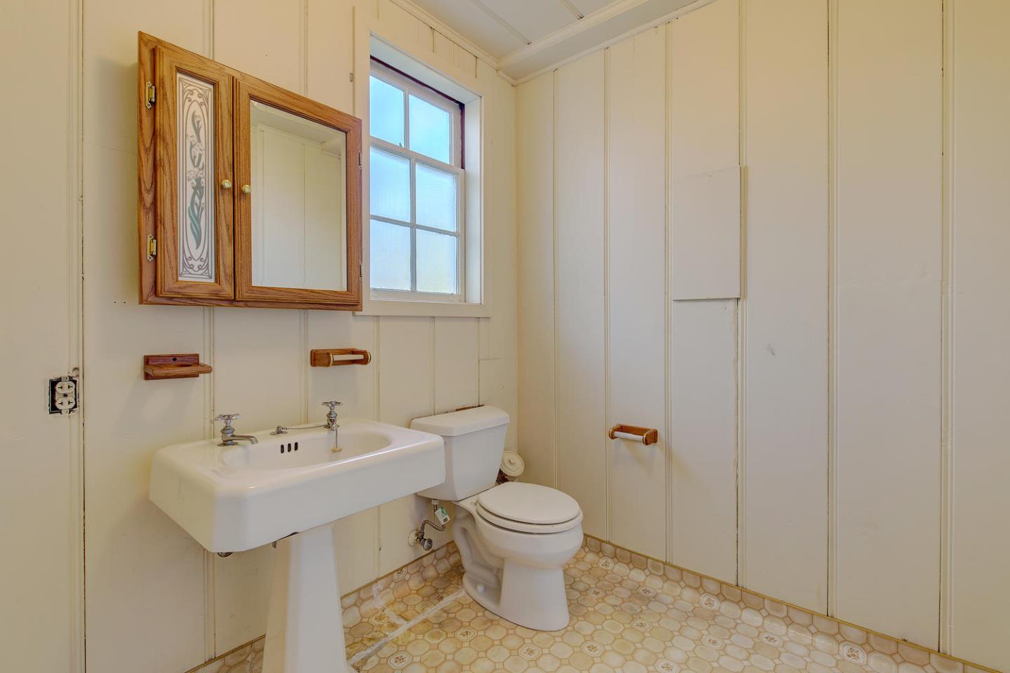 540 Roehampton Road Hillsborough, CA 94010 - Photo 22 of 27 a bathroom with a sink a toilet and mirror