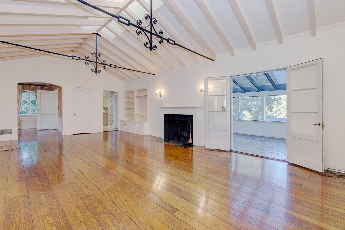 540 Roehampton Road Hillsborough, CA 94010 - Photo 4 of 27 a view of a livingroom with wooden floor and a kitchen space