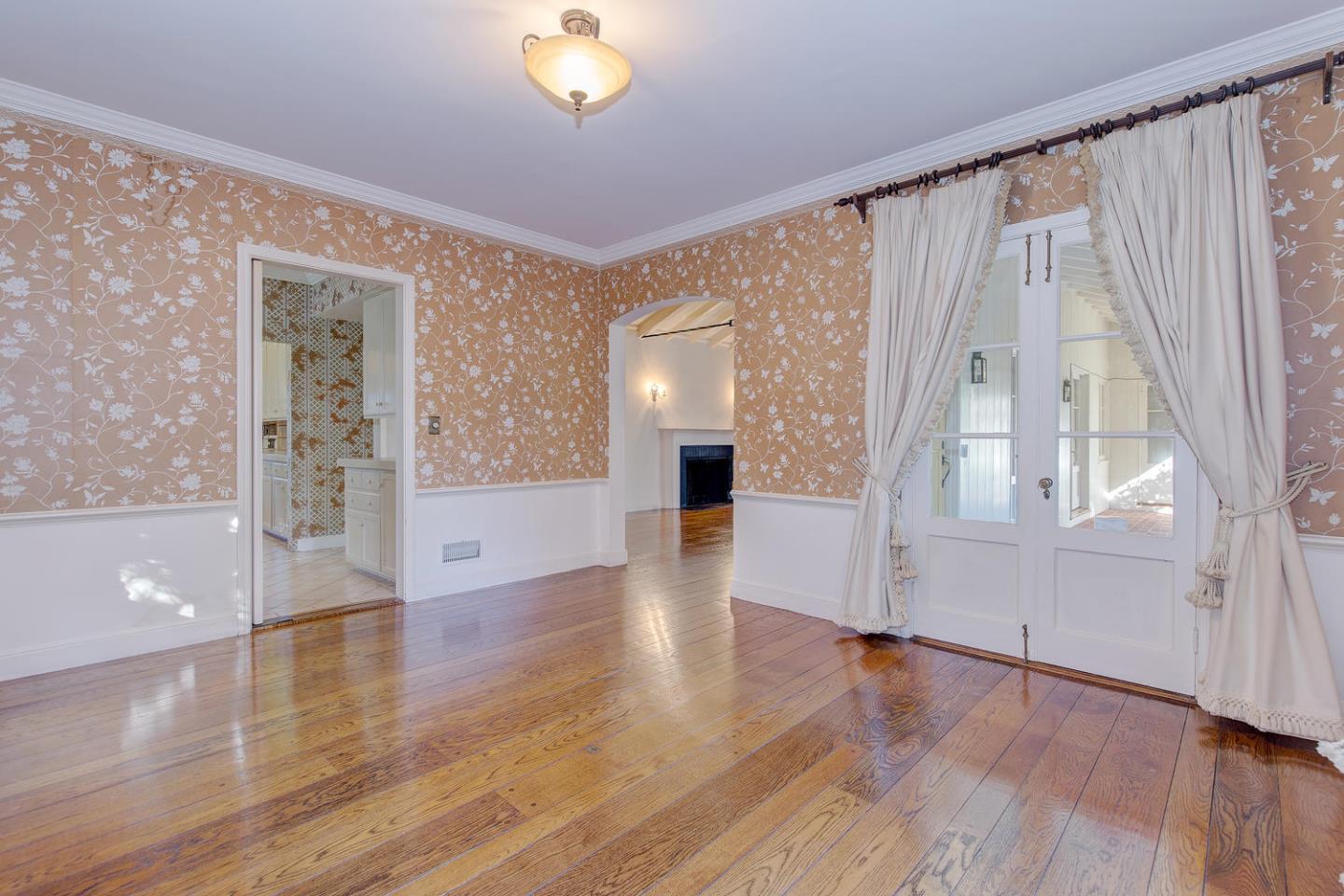 540 Roehampton Road Hillsborough, CA 94010 - Photo 7 of 27 a view of an empty room with wooden floor and a window