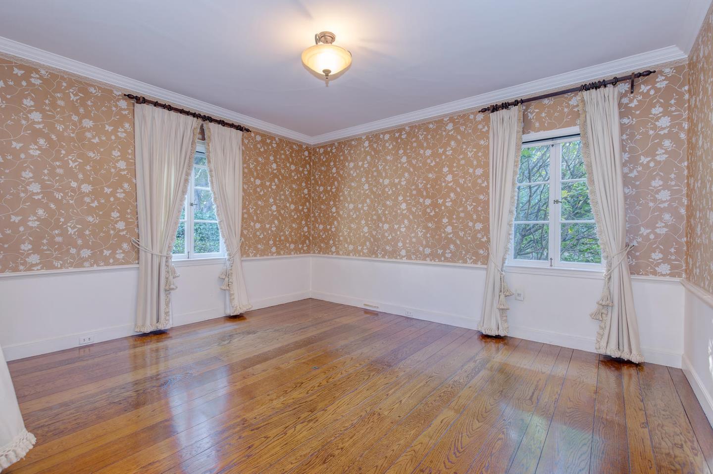 540 Roehampton Road Hillsborough, CA 94010 - Photo 8 of 27 an empty room with wooden floor and windows