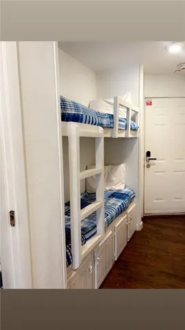 a kitchen with stainless steel appliances a refrigerator and wooden floor