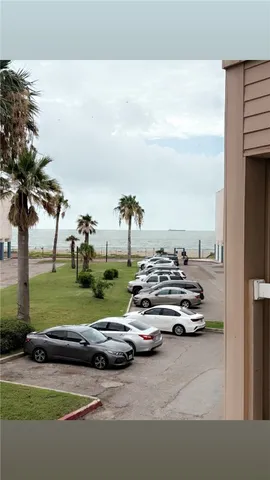 a view of a street with cars parked