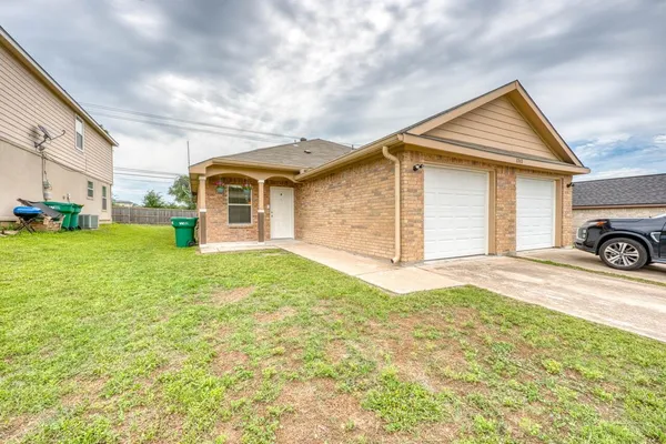 a view of a house with a yard and garage