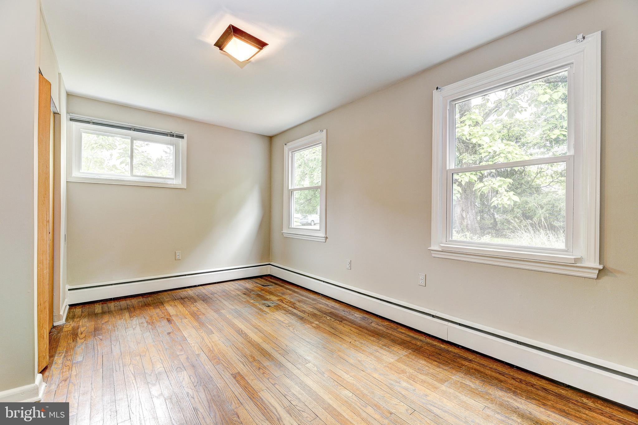 7500 Rocksham Drive Towson, MD 21286 - Photo 18 of 26 a view of an empty room with wooden floor and a window