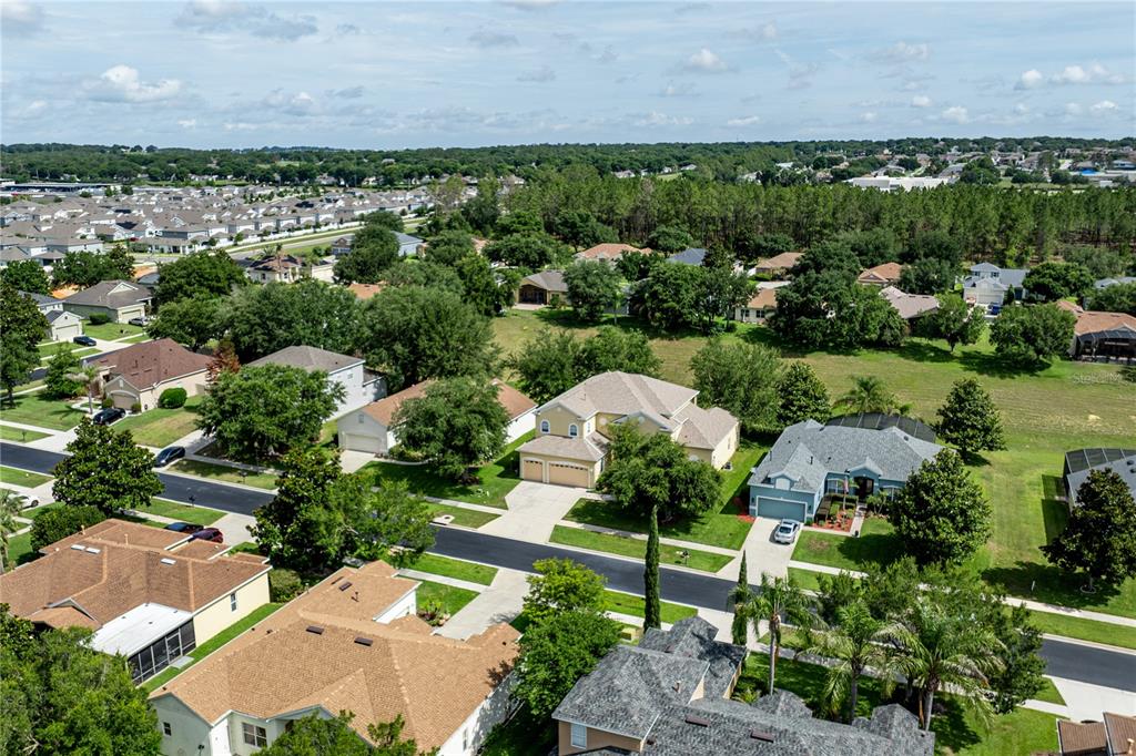 2718 Knightsbridge Road Clermont, FL 34711 - Photo 63 of 72 an aerial view of a house with a garden and lake view