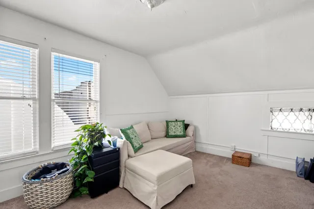 a view of a backyard with plants and a bench