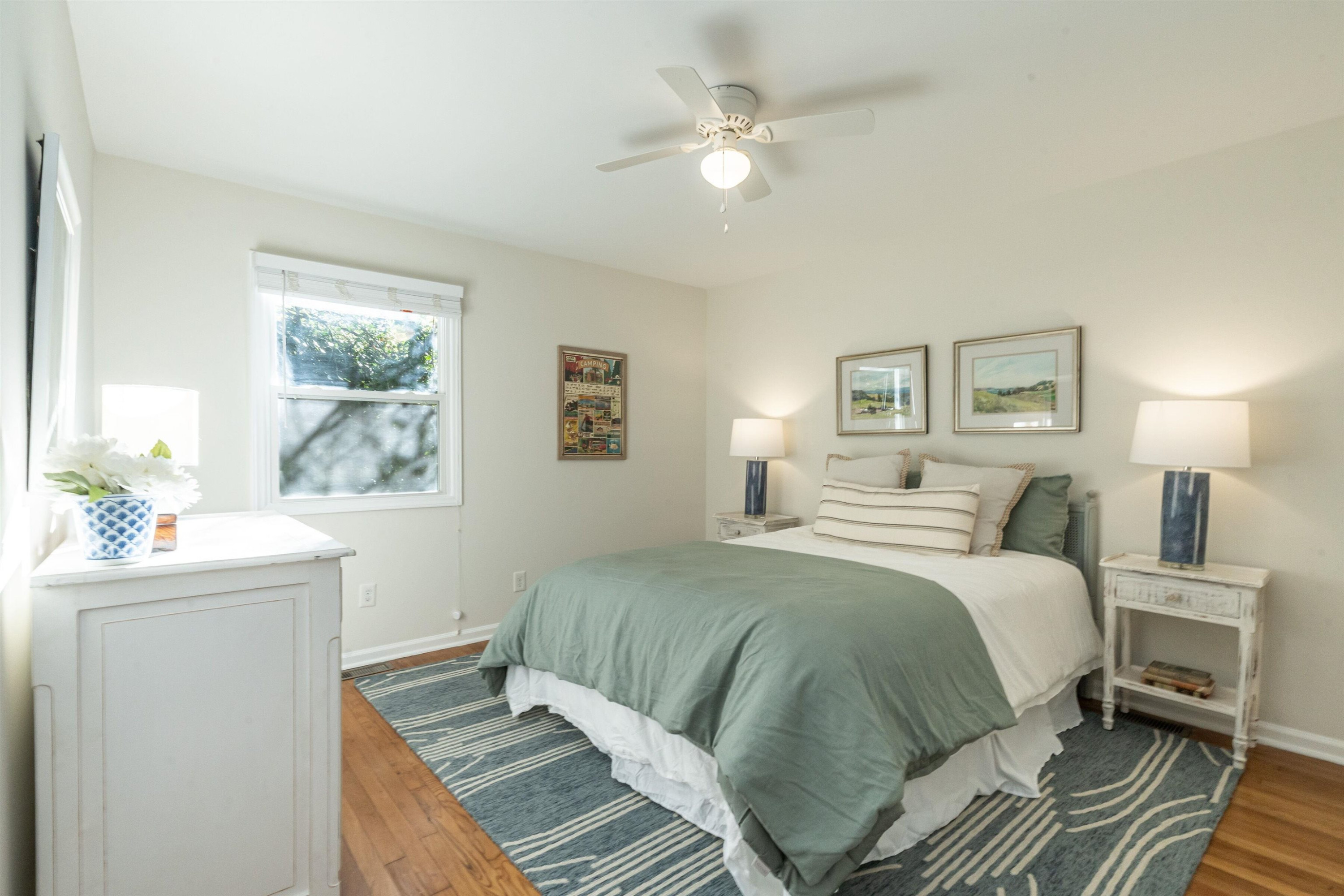 2408 Remington Road Raleigh, NC 27610 - Photo 22 of 31 a bedroom with a large bed a chandelier and a window