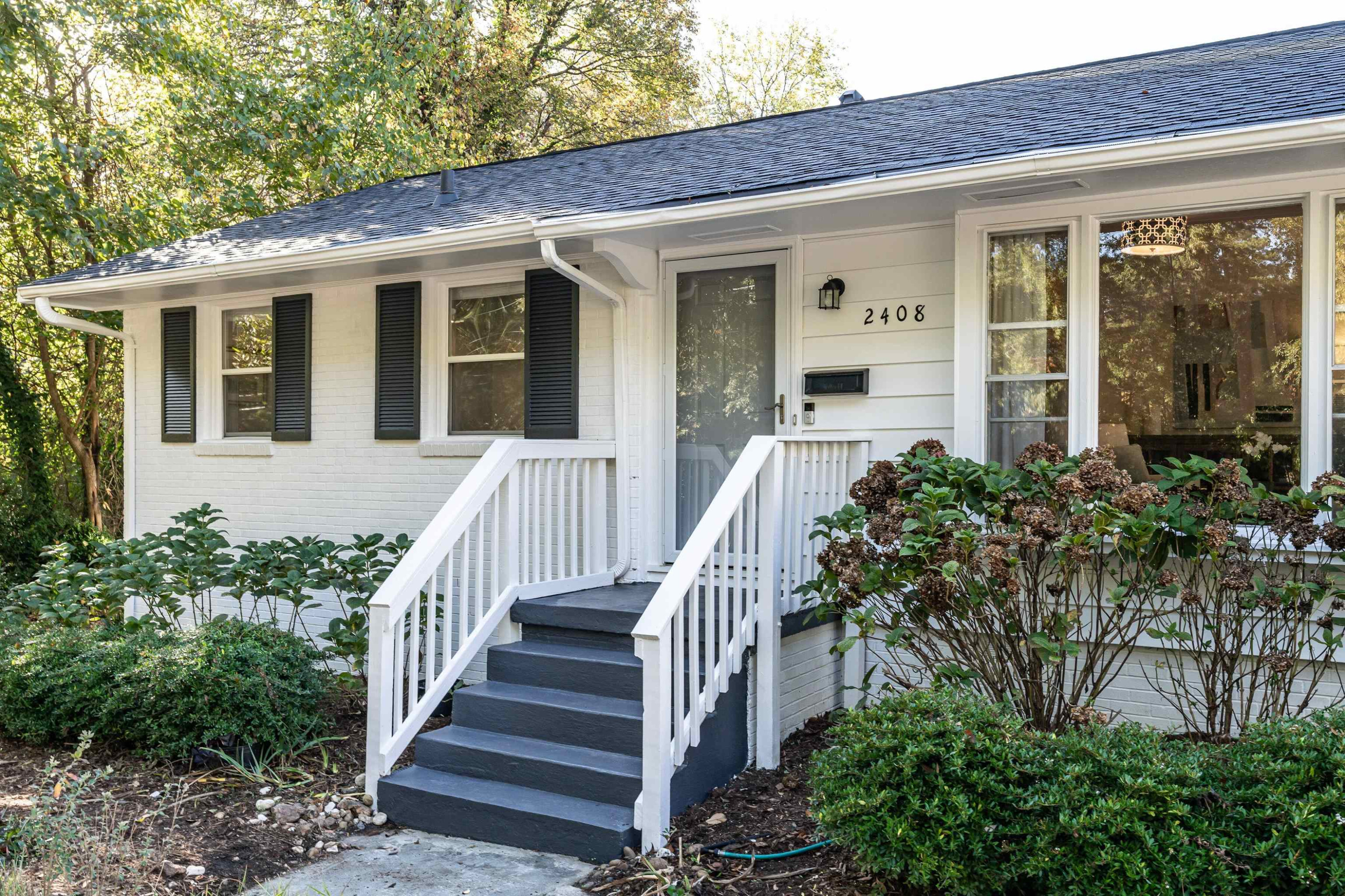 2408 Remington Road Raleigh, NC 27610 - Photo 3 of 31 a view of a house with more windows and flower plants