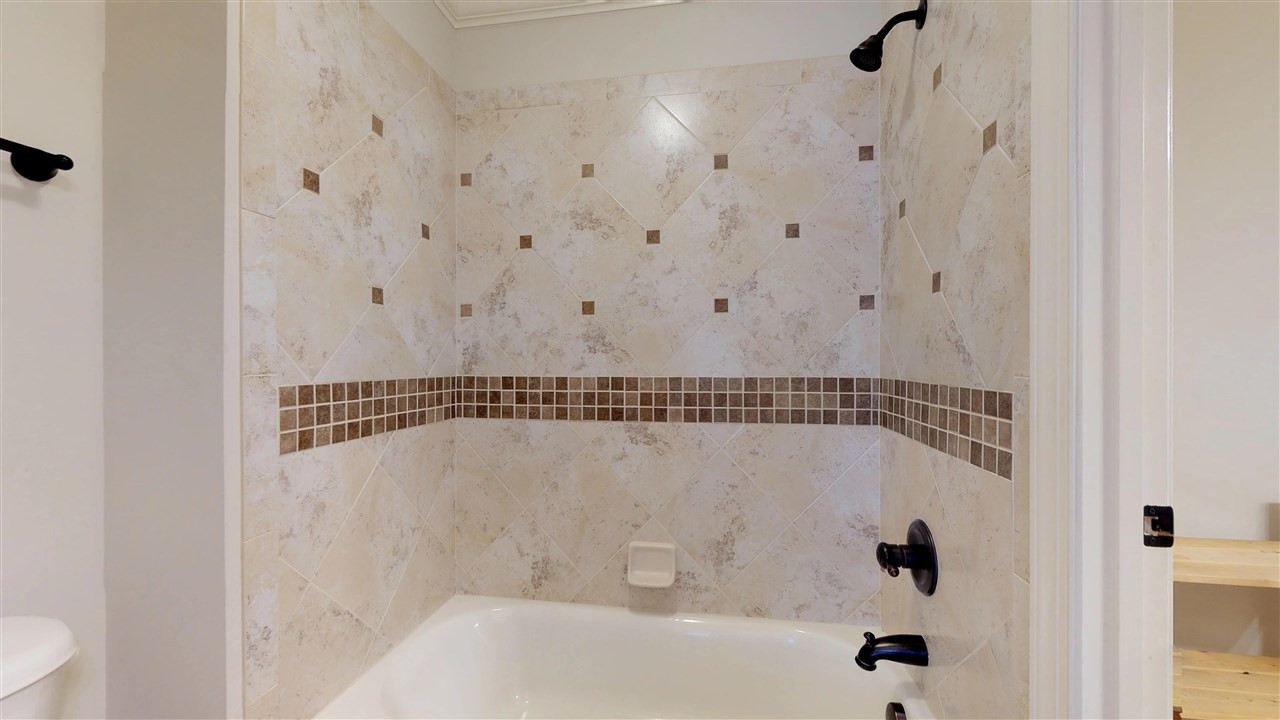 7313 Duncans Ridge Way Fuquay-Varina, NC 27526 - Photo 19 of 30 No detail was left out - look at the craftsmanship on the tile work! Jack and Jill Bath