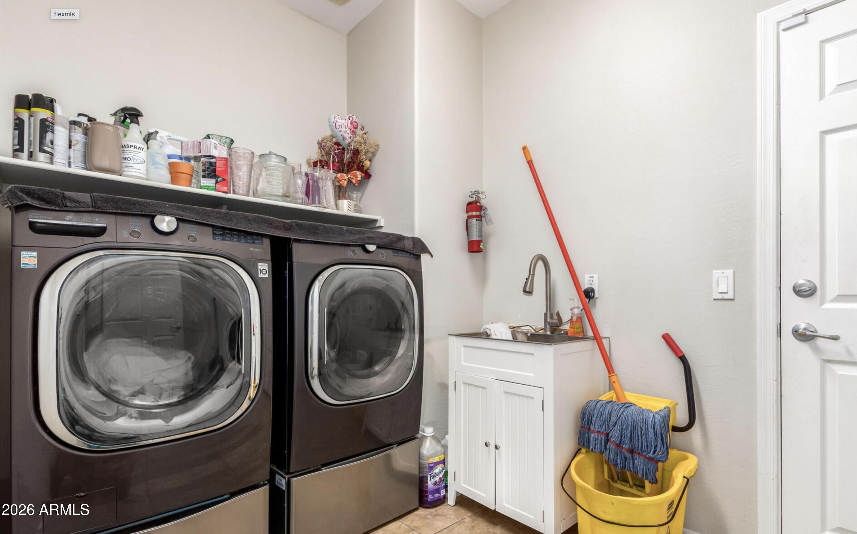 10225 West Camelback Road, Unit 12 Phoenix, AZ 85037 - Photo 19 of 19 a utility room with dryer and washer