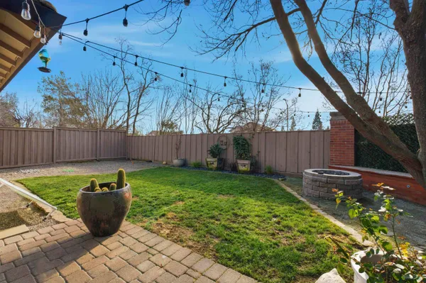 a view of a backyard with wooden fence