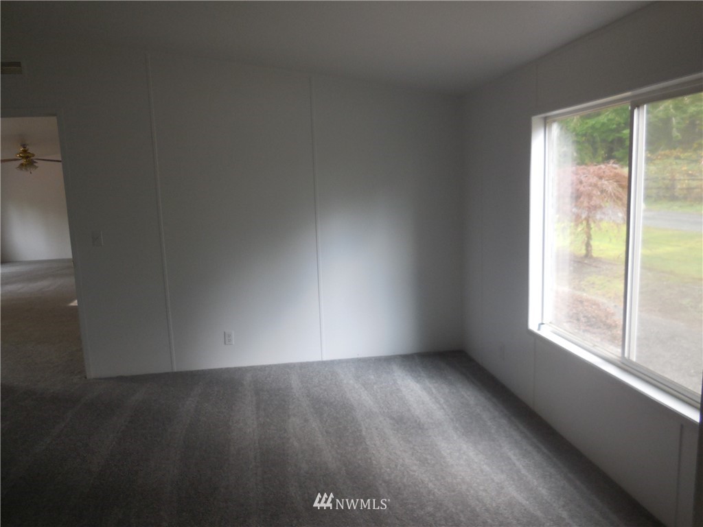 11510 Bollenbaugh Hill Road Monroe, WA 98272 - Photo 12 of 15 an empty room with wooden floor and windows