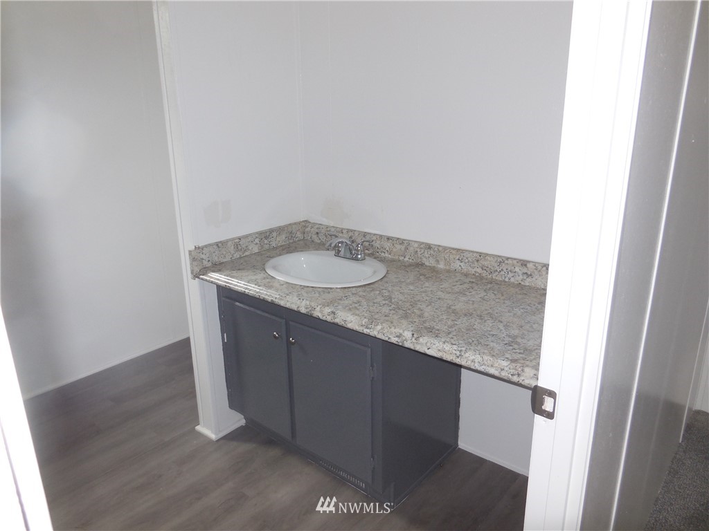11510 Bollenbaugh Hill Road Monroe, WA 98272 - Photo 13 of 15 a bathroom with a granite countertop sink and a mirror
