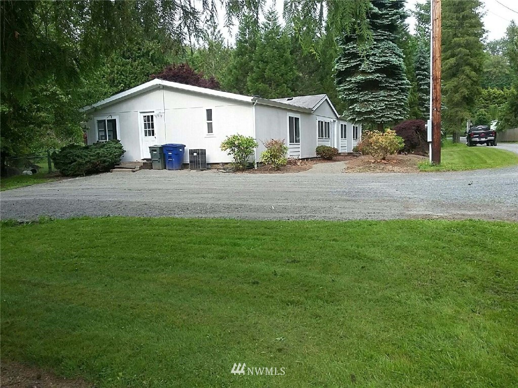 11510 Bollenbaugh Hill Road Monroe, WA 98272 - Photo 7 of 15 a view of a white house next to a yard and a road
