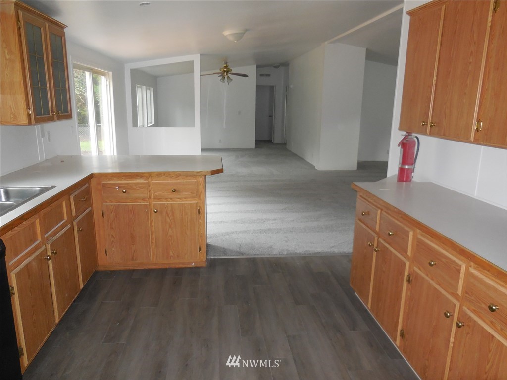 11510 Bollenbaugh Hill Road Monroe, WA 98272 - Photo 9 of 15 a kitchen with granite countertop white cabinets and white appliances
