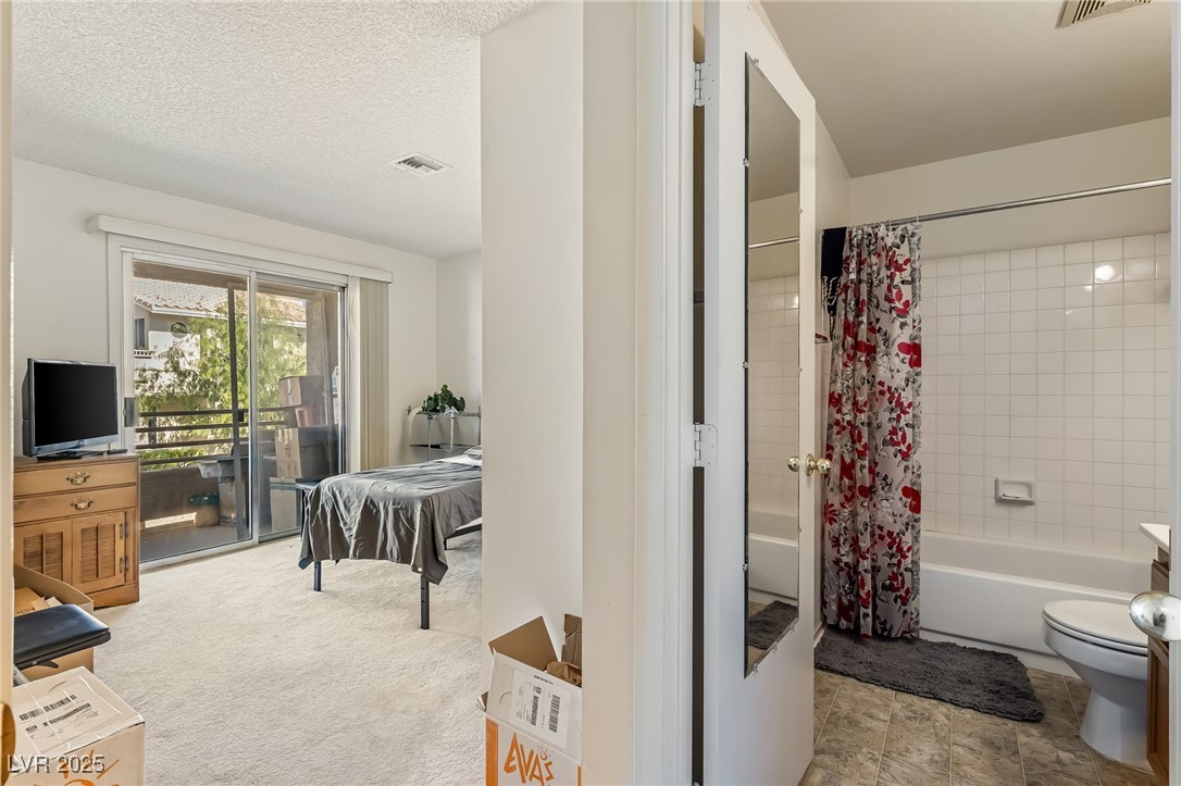 2180 Highpointe Drive, Unit 203 Laughlin, NV 89029 - Photo 11 of 20 Bathroom featuring shower / bath combination with curtain, vanity, and light carpet