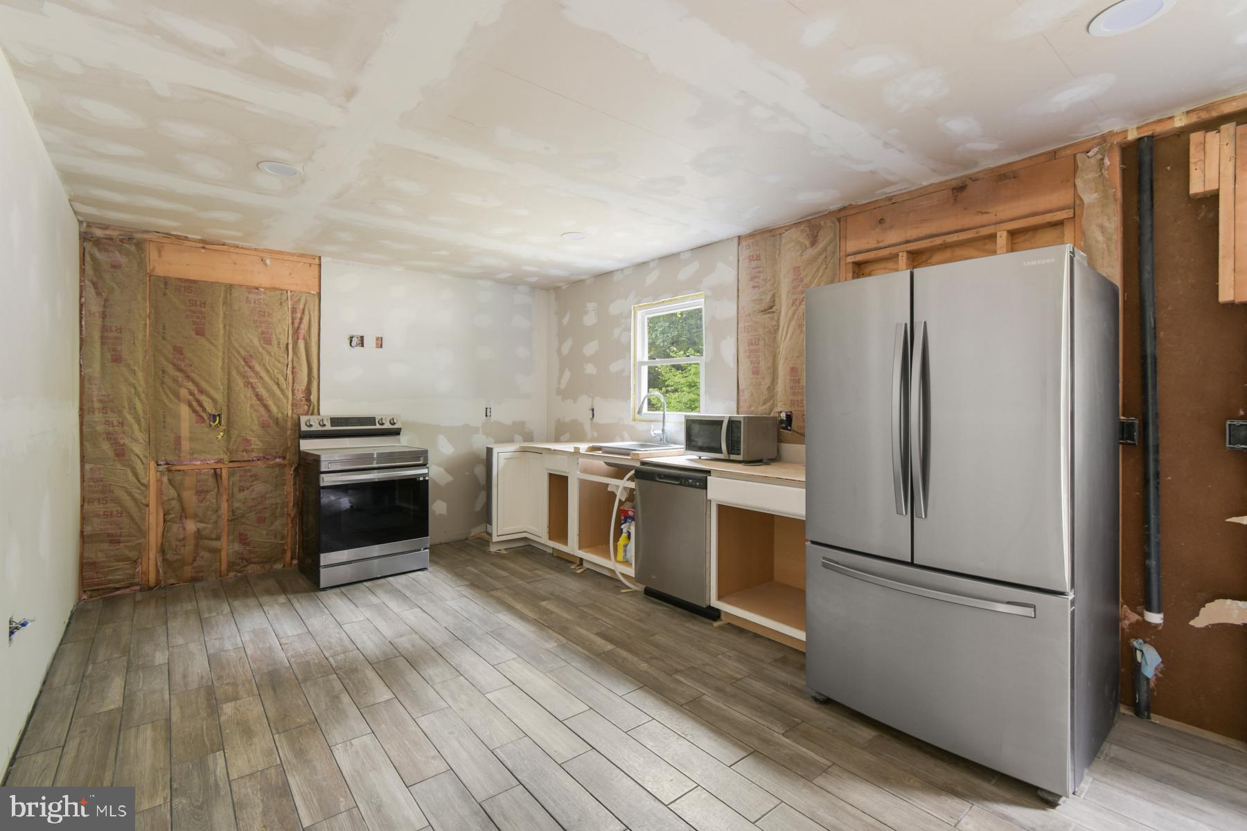 32548 Mt Olive Road Salisbury, MD 21804 - Photo 12 of 16 a kitchen with a refrigerator and a stove top oven
