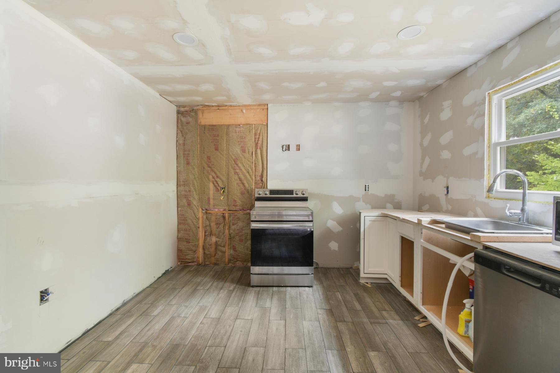 32548 Mt Olive Road Salisbury, MD 21804 - Photo 13 of 16 a kitchen with a sink stove and cabinets