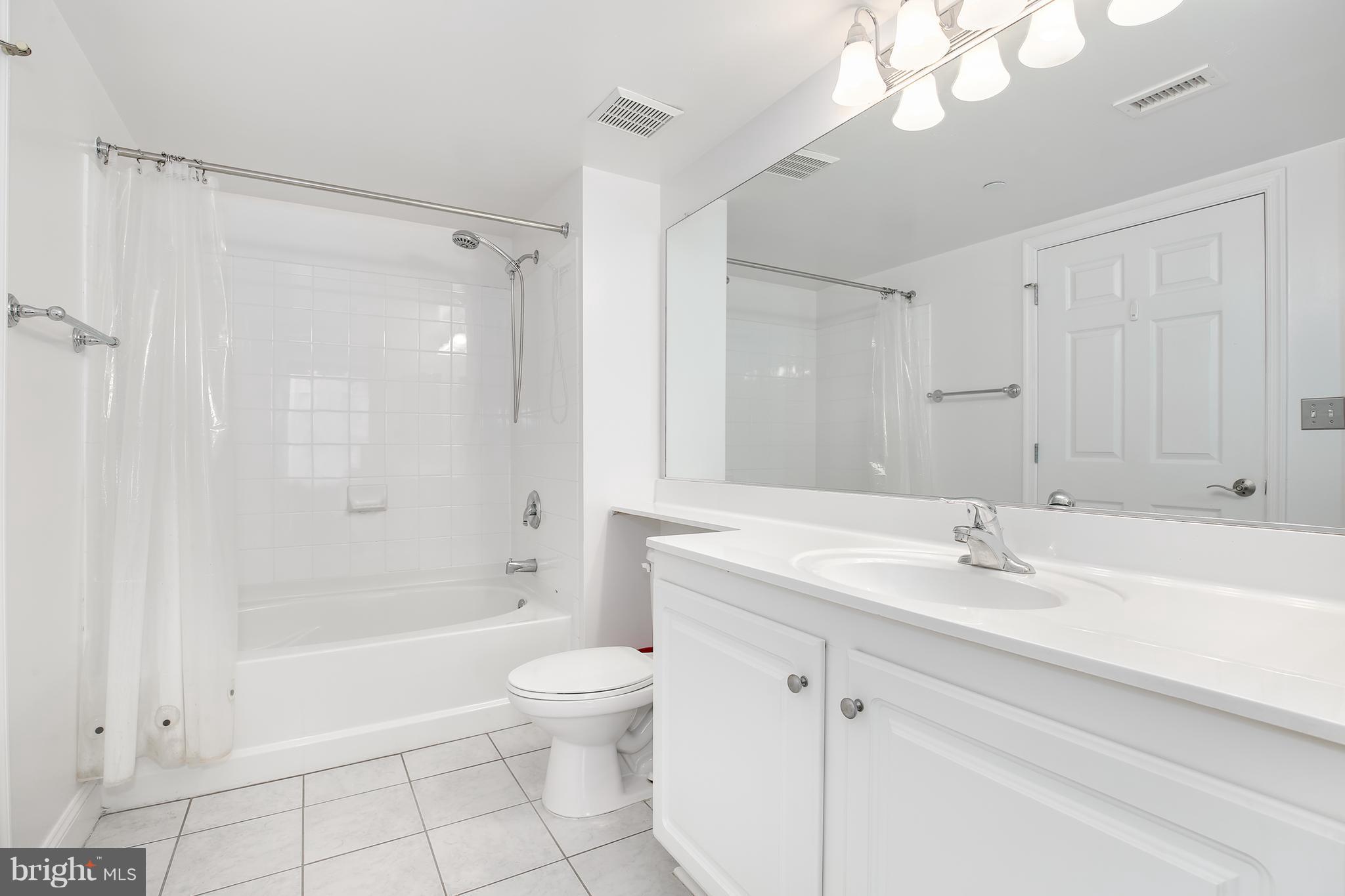 11710 Old Georgetown Road, Unit 1124 North Bethesda, MD 20852 - Photo 15 of 30 a bathroom with a sink a toilet and shower