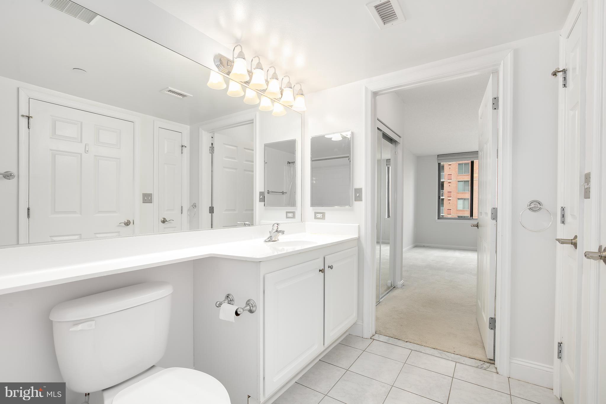 11710 Old Georgetown Road, Unit 1124 North Bethesda, MD 20852 - Photo 16 of 30 a bathroom with a sink a toilet and shower