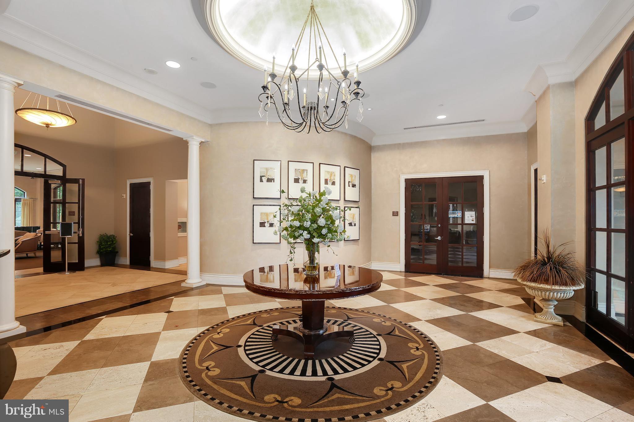 11710 Old Georgetown Road, Unit 1124 North Bethesda, MD 20852 - Photo 23 of 30 a living room with fireplace and a chandelier