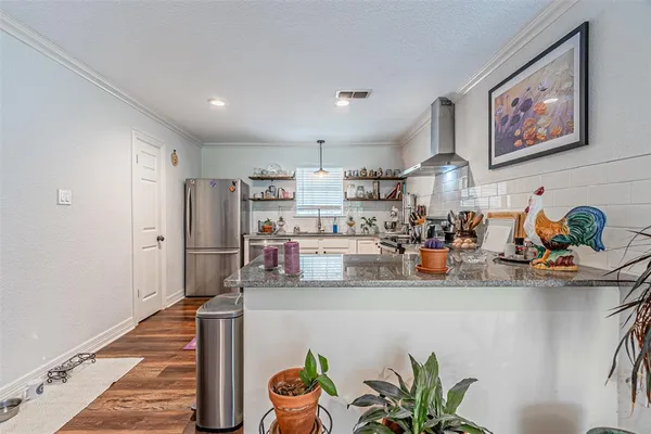 a kitchen with stainless steel appliances and cabinets