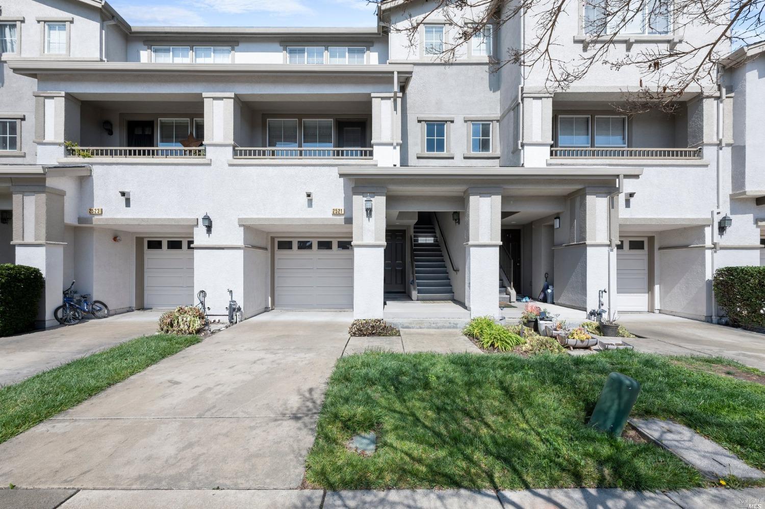 2521 Edgewater Drive Santa Rosa, CA 95407 - Photo 1 of 1 a view of a white house with large windows and a small yard