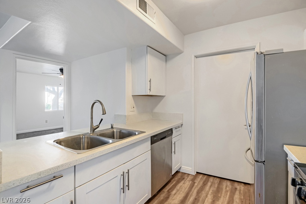 7885 West Flamingo Road, Unit 1003 Las Vegas, NV 89147 - Photo 12 of 22 Smooth countertops and modern cabinetry line this updated kitchen space.