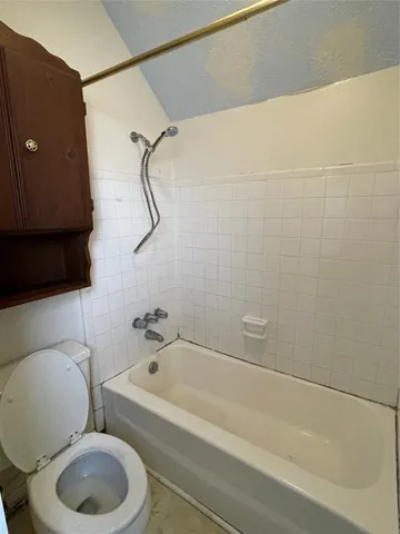 a bathroom with a toilet and a bathtub