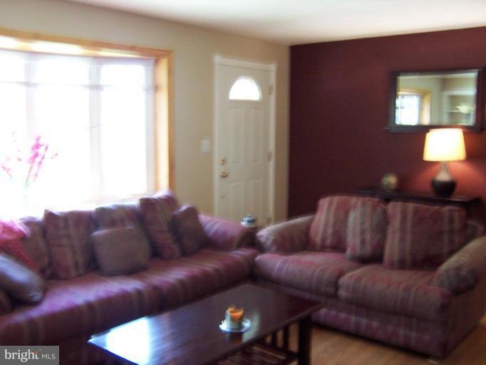 9904 Renfrew Road Silver Spring, MD 20901 - Photo 11 of 15 a living room with furniture a lamp and a window