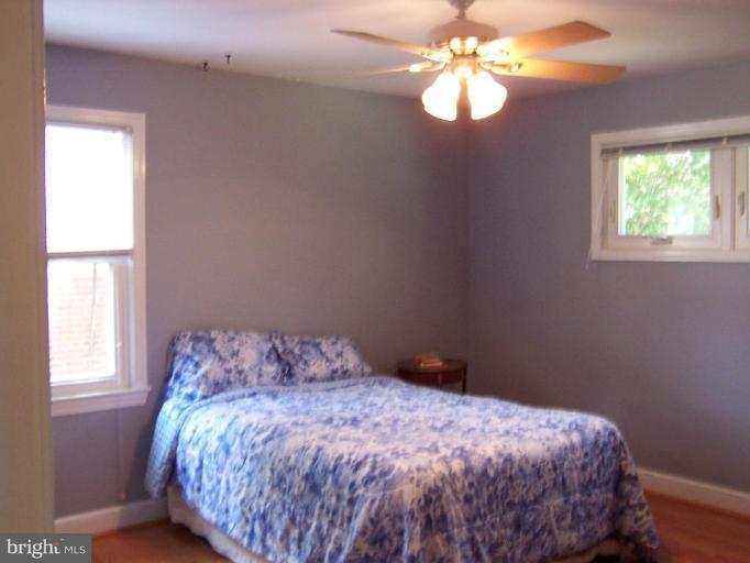 9904 Renfrew Road Silver Spring, MD 20901 - Photo 13 of 15 a bedroom with a bed and a window