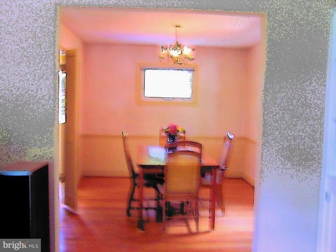 9904 Renfrew Road Silver Spring, MD 20901 - Photo 14 of 15 a view of a dining room with furniture and wooden floor