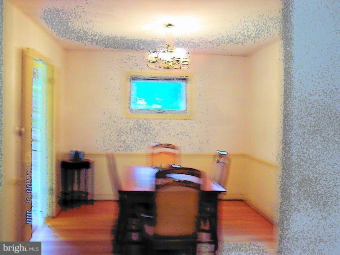 9904 Renfrew Road Silver Spring, MD 20901 - Photo 7 of 15 a dining room with furniture and wooden floor