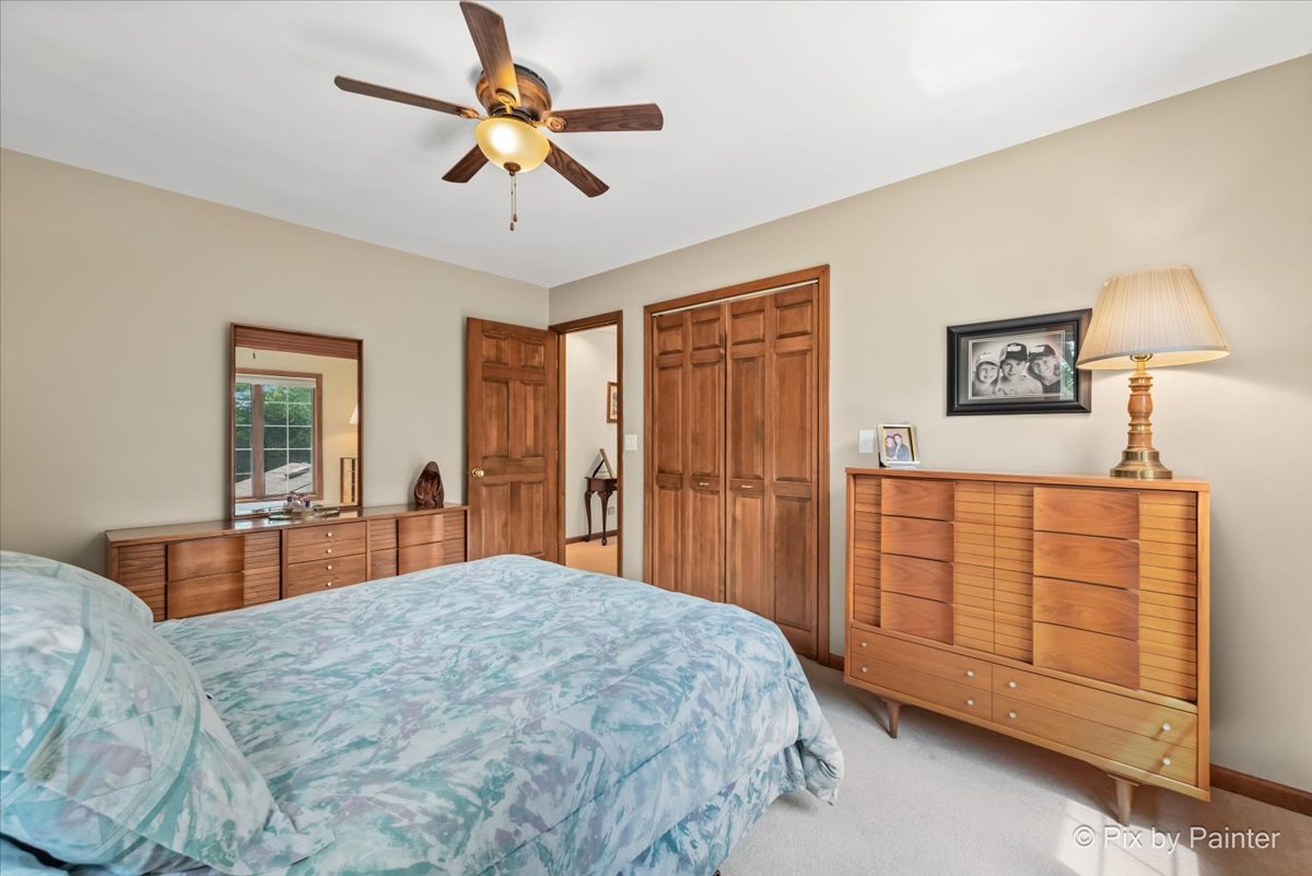 2N445 Beith Road Elburn, IL 60119 - Photo 30 of 58 a bedroom with a bed and a chandelier