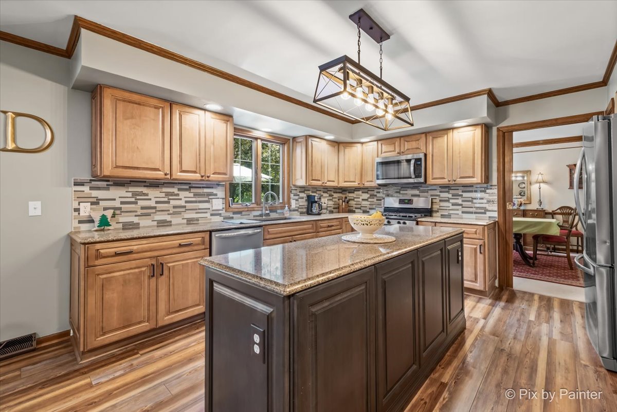 2N445 Beith Road Elburn, IL 60119 - Photo 5 of 58 a kitchen with stainless steel appliances granite countertop a sink stove and cabinets