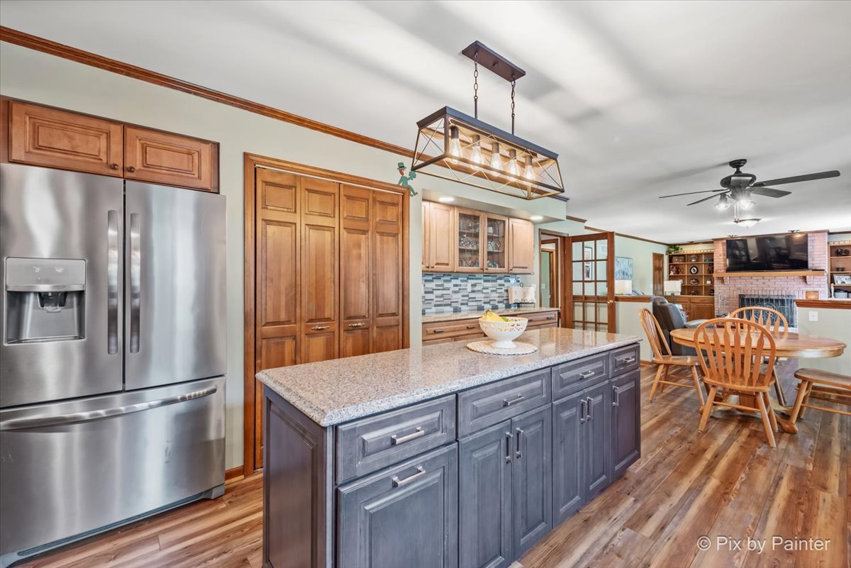 2N445 Beith Road Elburn, IL 60119 - Photo 8 of 58 a kitchen with stainless steel appliances a table chairs and chandelier