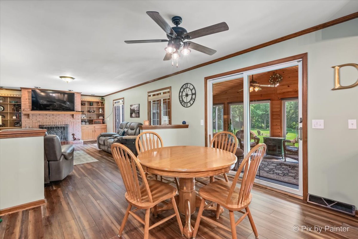 2N445 Beith Road Elburn, IL 60119 - Photo 9 of 58 a dining room with furniture a chandelier and wooden floor