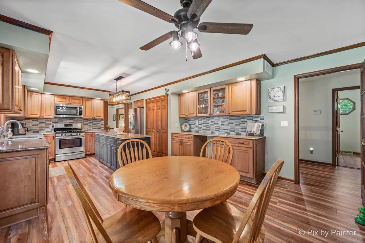 2N445 Beith Road Elburn, IL 60119 - Photo 10 of 58 a dining room with stainless steel appliances a dining table wooden floor and a kitchen view