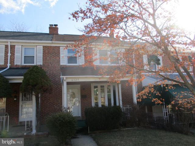 6125 Dunroming Road Baltimore, MD 21239 - Photo 1 of 21 a front view of a house with a yard