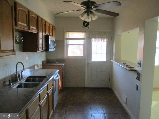 6125 Dunroming Road Baltimore, MD 21239 - Photo 8 of 21 a kitchen with a sink a counter space cabinets and appliances