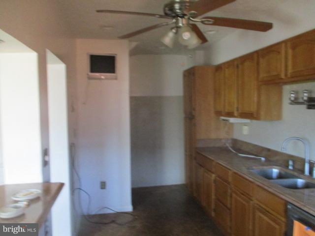 6125 Dunroming Road Baltimore, MD 21239 - Photo 9 of 21 a kitchen with a sink and a refrigerator