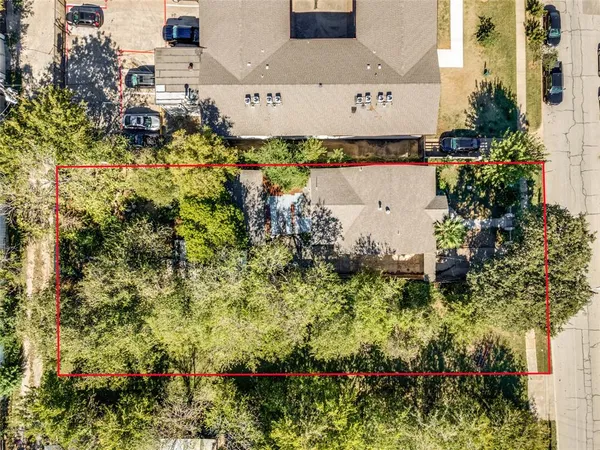 an aerial view of a house with a yard and lake view