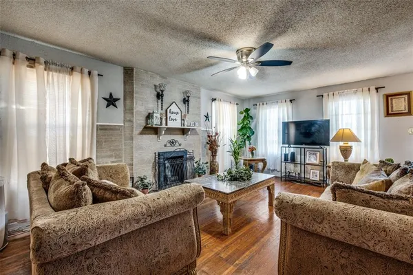 a living room with furniture a flat screen tv and a fireplace