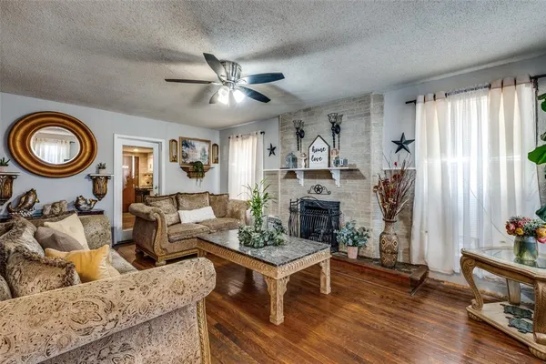 a living room with furniture a fireplace and a window