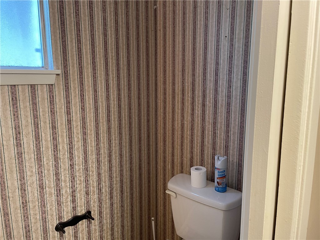 5218 Wooldridge Road Corpus Christi, TX 78413 - Photo 13 of 29 a bathroom with a toilet and a shower curtain