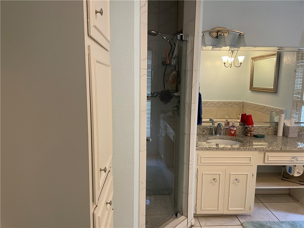 5218 Wooldridge Road Corpus Christi, TX 78413 - Photo 19 of 29 a bathroom with a sink and a mirror