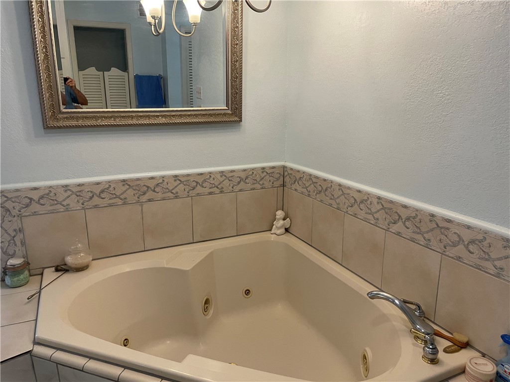 5218 Wooldridge Road Corpus Christi, TX 78413 - Photo 20 of 29 a bathroom with a bathtub