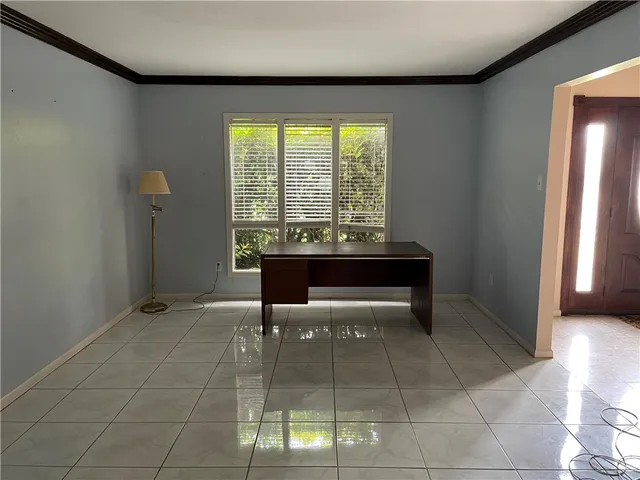 a dining room with furniture and window