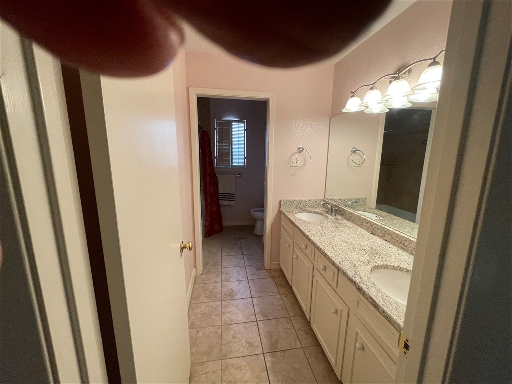 5218 Wooldridge Road Corpus Christi, TX 78413 - Photo 23 of 29 a bathroom with a granite countertop sink and a mirror