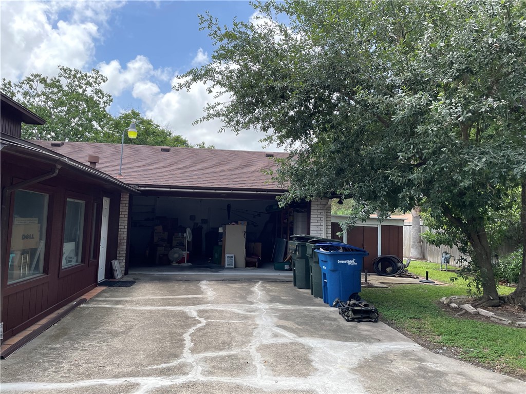 5218 Wooldridge Road Corpus Christi, TX 78413 - Photo 28 of 29 a view of a house with a barbeque and a large tree